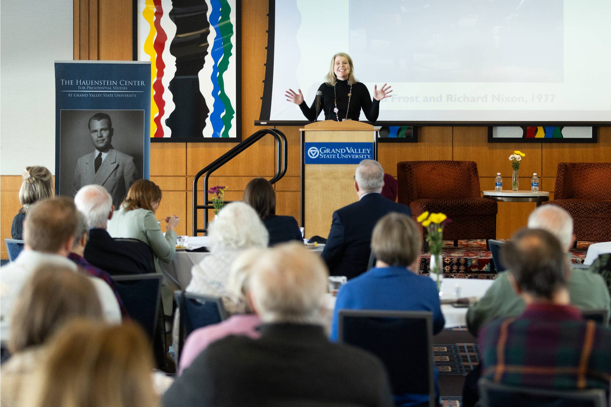 person speaking at a podium